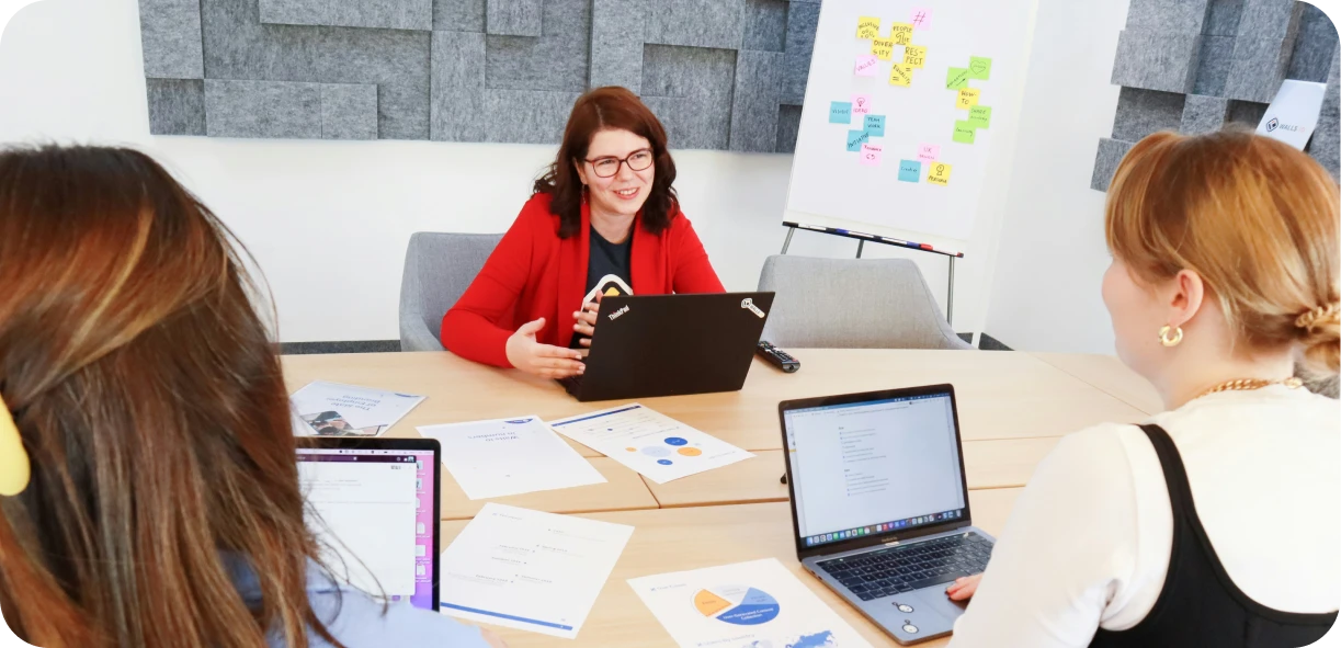 Event rental sales team member receiving constructive feedback during a call review session, analyzing client interactions to improve sales techniques.